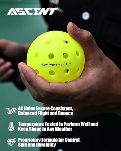 Person holding a yellow Ascent pickleball with text highlighting features.