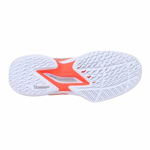 Bottom view of an athletic shoe sole with orange and white design.