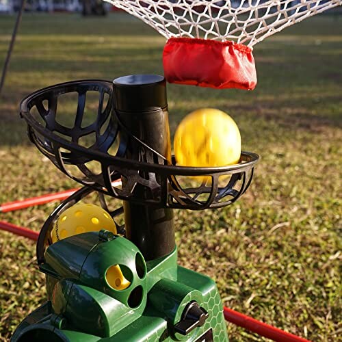 Automatic ball launcher with a net catching a yellow ball.