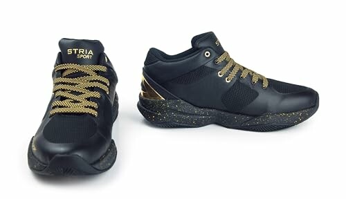 Black sneakers with gold details and laces.