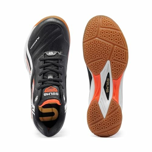 Pair of black and orange sports shoes, top and sole view.