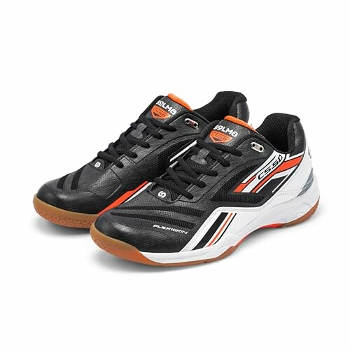 Black sports shoes with orange and white accents