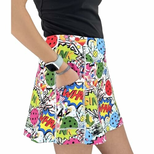 Person wearing a colorful comic-patterned skirt with pockets