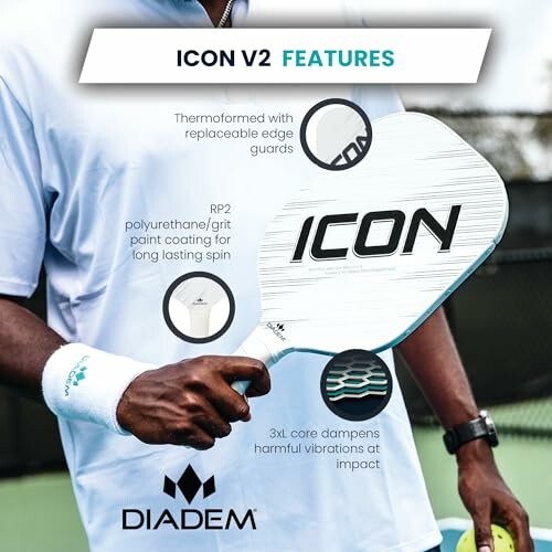 Person holding Diadem Icon V2 pickleball paddle with feature highlights.