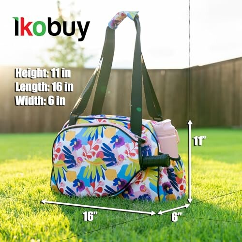 Floral patterned gym bag with dimensions in a grassy yard.