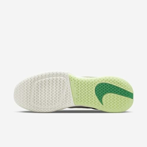 Bottom view of a sneaker with a green and white sole.