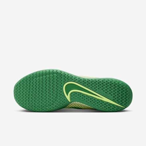 Bottom view of a green sneaker with a distinct tread pattern