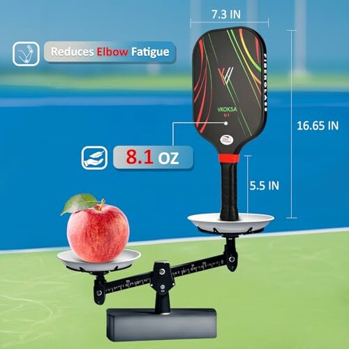 Pickleball paddle on scale balancing with apple, showing weight and dimensions.