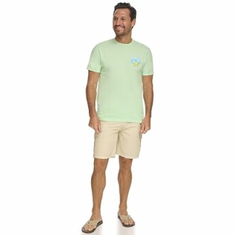 Man wearing a light green t-shirt and beige shorts with sandals.