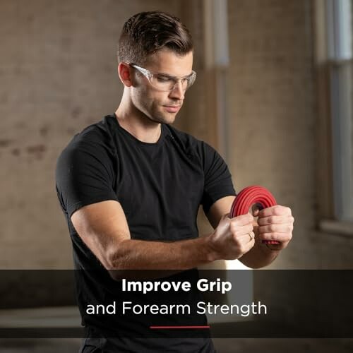 Man using a red hand grip for forearm exercise