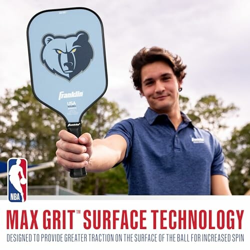 Man holding a pickleball paddle with NBA Max Grit Surface Technology.