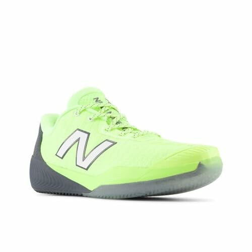 Neon green New Balance sneaker with grey sole, designed for optimal performance on indoor courts.