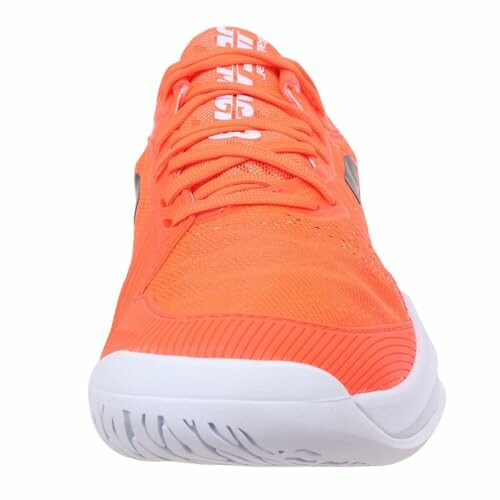 Front view of an orange sneaker with white sole.