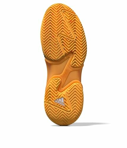 Orange sneaker sole with zigzag tread pattern