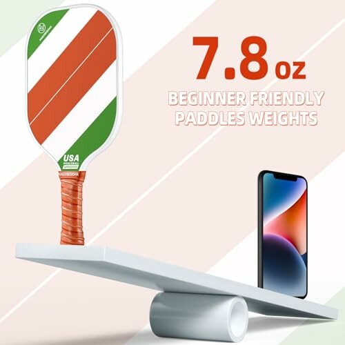 Pickleball paddle balanced with smartphone showing weight of 7.8 oz.