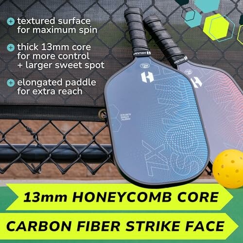 Two pickleball paddles with textured surface and elongated design, highlighting 13mm honeycomb core and carbon fiber strike face.