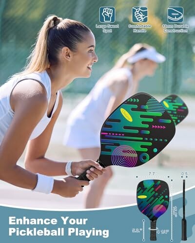 Two women playing pickleball on a court with colorful paddles.