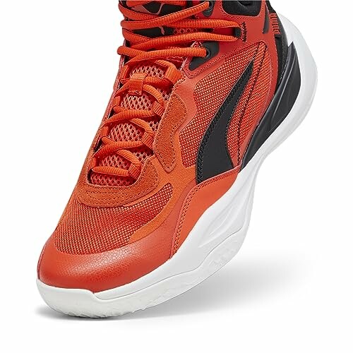 Red and black basketball sneaker with white sole