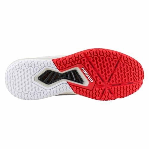 Red and white tennis shoe sole with patterned tread.