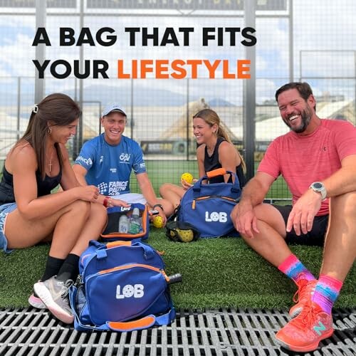 Group of four people sitting outdoors with sports bags, smiling and interacting.