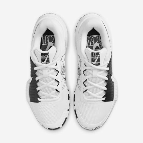 Top view of white and black Nike sneakers with graphic insoles.