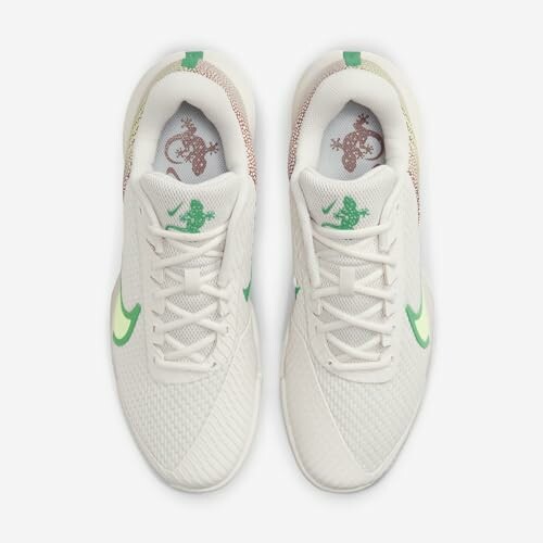 Top view of white sneakers with green accents and lizard design on insoles.