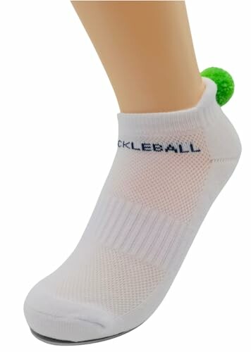 White pickleball sock with green pom-pom.