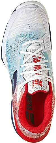 Top view of a white, red, and blue sneaker with laces