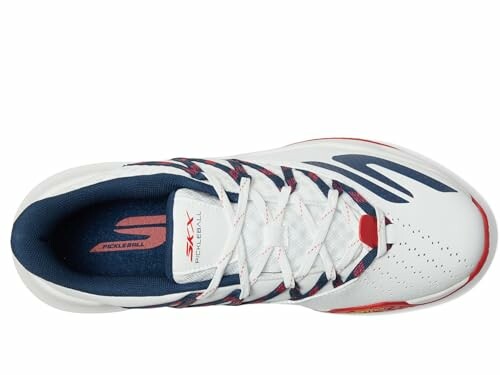 Top view of a white sports shoe with red and blue accents