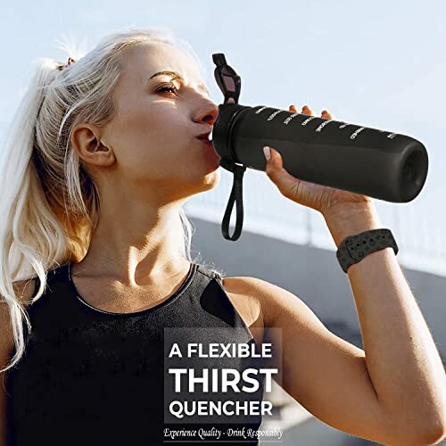 Woman drinking from a black water bottle outdoors.