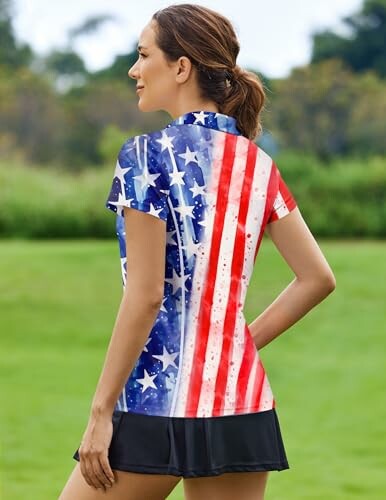 Woman wearing a shirt with American flag design standing outdoors.