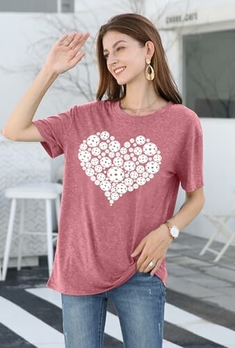 Woman in red t-shirt with heart design waving outside