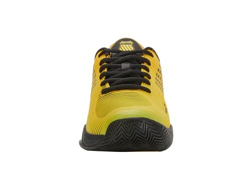 Front view of a yellow sports shoe with black laces